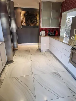 a kitchen with a large white tile floor in a kitchen at Blue Valley Golf Estate in Centurion