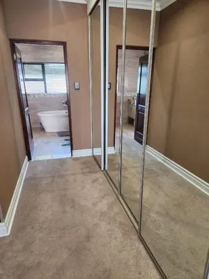 a bathroom with mirrors in a room with a tub at Blue Valley Golf Estate in Centurion