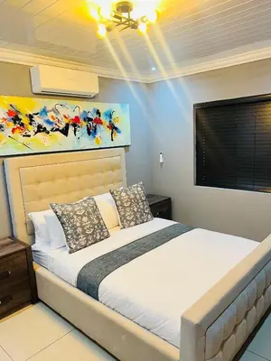 a bedroom with a bed in a room at 9 on Burger Blue Waters in Polokwane