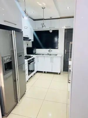 a kitchen with stainless steel appliances and white cabinets at 9 on Burger Blue Waters in Polokwane