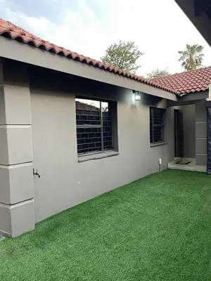 a backyard of a house with a green lawn at 9 on Burger Blue Waters in Polokwane