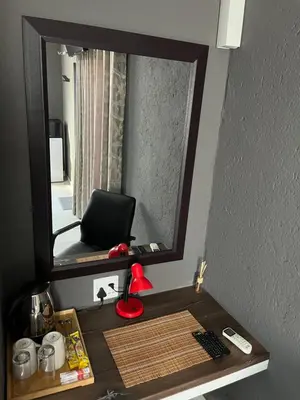 a mirror sitting on top of a desk in a room at Família BnB in Tekwane