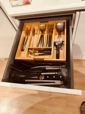a drawer full of knives and other kitchen utensils at Homely - 1 bedroom rental unit at Ellipse in Midrand