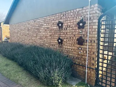 a brick wall with two parking meters on it at Revenir in Middelburg