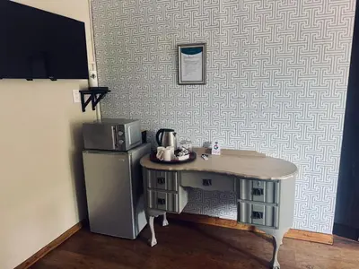 a kitchen with a small table next to a refrigerator at Revenir in Middelburg
