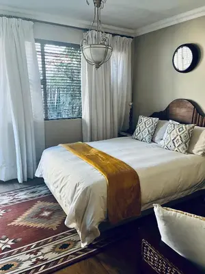 a bedroom with a large bed with a chandelier at Revenir in Middelburg