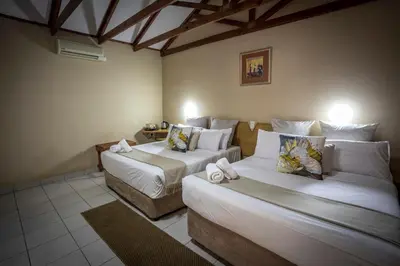 a room with two beds in a room at Bolivia Lodge in Polokwane
