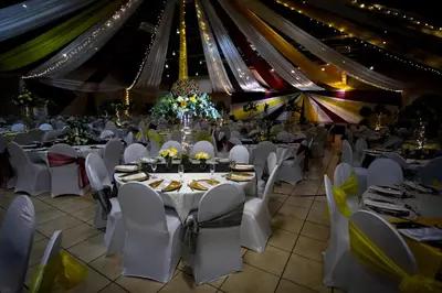 a banquet hall with tables and chairs and a tent at Bolivia Lodge in Polokwane