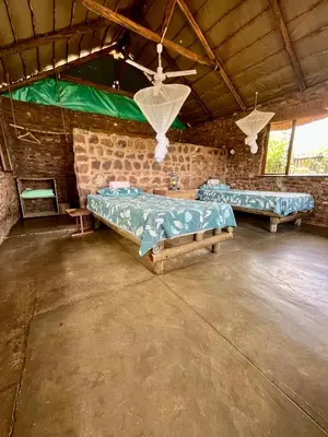 a room with two beds in a brick wall at Kaoxa Bush Camp in Alldays