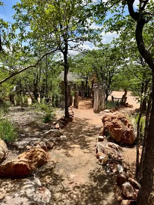 a dirt path in a forest with trees and rocks at Kaoxa Bush Camp in Alldays