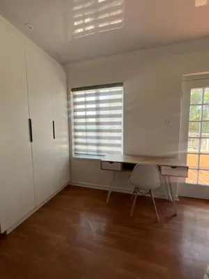 an empty room with a desk and a chair at Charming Urban Retreat in Centurion