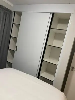 a bedroom with a bed and a white closet at Tranquil 2 bed 2 bath studio in Sandton