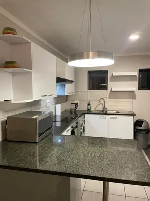 a kitchen with a counter top with a microwave at Tranquil 2 bed 2 bath studio in Sandton