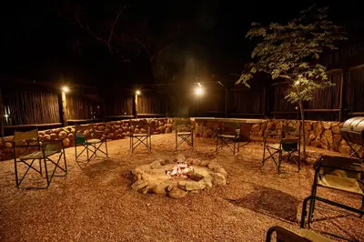 a fire pit in the middle of a yard at night at The Riverine Lodge in Welgevonden Game Reserve