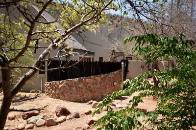 a fence in front of a house at The Riverine Lodge in Welgevonden Game Reserve