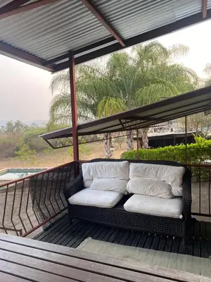 a couch sitting on top of a porch at Home Sweet Home Farmhouse in Nelspruit