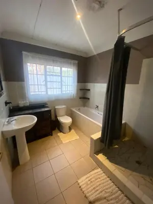 a bathroom with a tub and a toilet and a sink at Home Sweet Home Farmhouse in Nelspruit