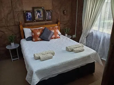 a bedroom with a bed with two towels on it at La Mathil in Swartspruit