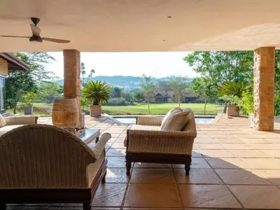 a living room with couches and a patio at African Dream Villa in White River