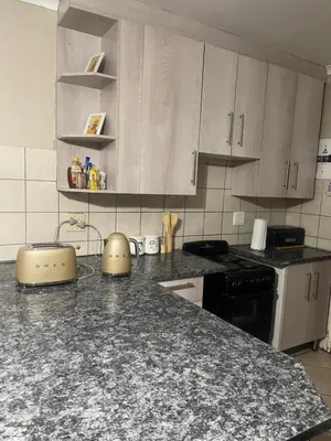 a kitchen with a counter top with a stove top oven at Tan 46 Park Acres in Nelspruit