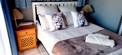 a bedroom with a bed with two tigers pillows at Lyttelton Self-Catering Accommodation in Centurion