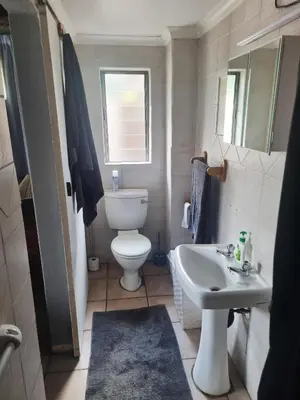 a small bathroom with a toilet and a sink at Lyttelton Self-Catering Accommodation in Centurion