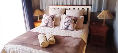 a bedroom with a bed with pillows on it at Lyttelton Self-Catering Accommodation in Centurion