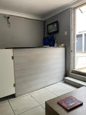 a kitchen with a sliding door and a window at DA LIFE Guest House in Springs
