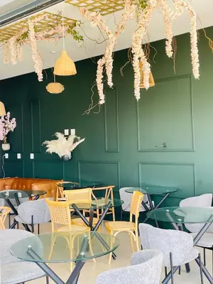 a restaurant with chairs and tables and a green wall at Peaceful Nest in Midrand