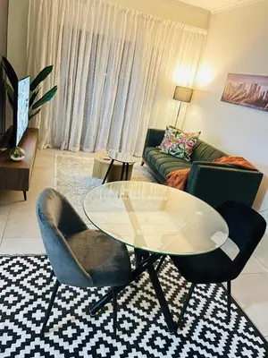 a living room with a glass table and two chairs at Peaceful Nest in Midrand