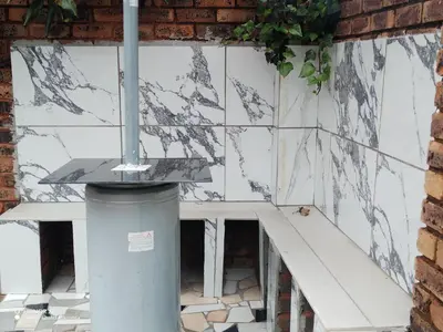 a white tiled wall with a staircase in a building at Home of peace and tranquility in Pretoria