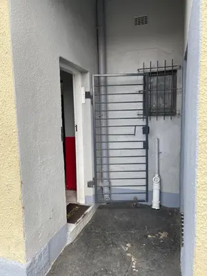 an entrance to a garage with a metal door at Good Time Guest House in Springs