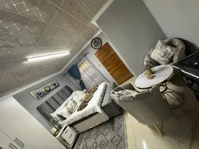 an overhead view of a living room with a couch and a table at StayComfyGuesthouseByPunky in Soshanguve
