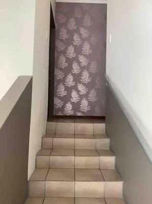 a staircase leading up to a room with a purple wall at 177 San Ridge Village in Midrand