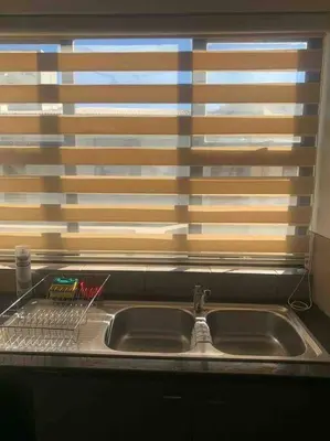 a kitchen sink in front of a window at 177 San Ridge Village in Midrand