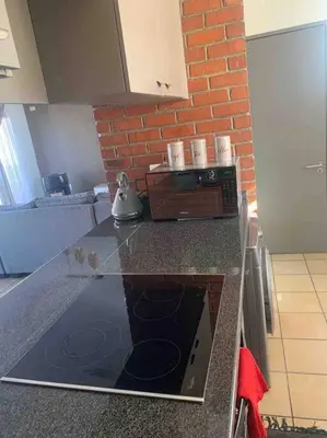 a kitchen with a counter top with a microwave at 177 San Ridge Village in Midrand