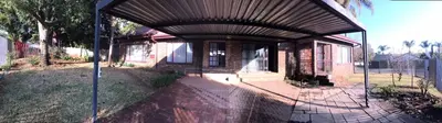 a brick house with an awning over the front of it at Sandgrouse Guesthouse in Centurion