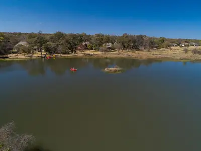 a large body of water with two boats in it at Waterberg Game Park in Mokopane