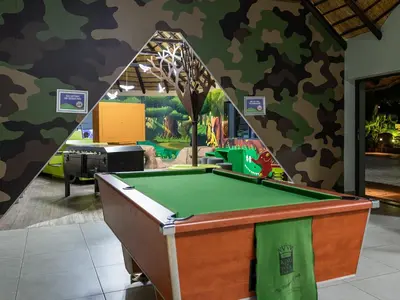 a billiards table in a room with a mural at Waterberg Game Park in Mokopane