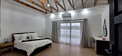 a bedroom with a bed and a large window at Golden Treasure - OFF GRID in Witbank