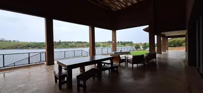 a room with a table and chairs and a view of the water at Golden Treasure - OFF GRID in Witbank