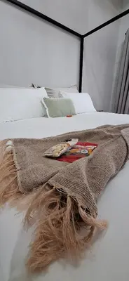 a blanket on top of a white bed at Golden Treasure - OFF GRID in Witbank