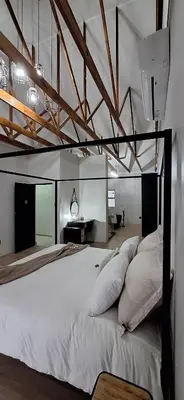 a bedroom with a large bed with white pillows at Golden Treasure - OFF GRID in Witbank