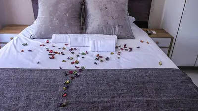 a bed with a bunch of flowers on it at Nsuku Guest House in Phalaborwa