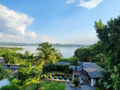 an aerial view of a house with a lake in the background at Mountain Dreamers in Hartbeespoort