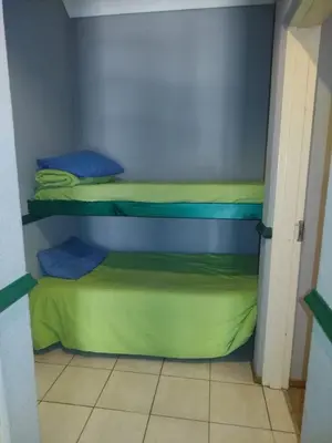 a small room with two bunk beds with green sheets at 27 Pendleberry Grove, Chris Hani Drive, Bela-Bela in Bela-Bela