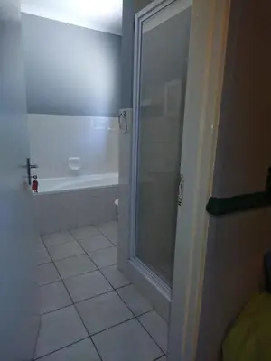 a bathroom with a shower and a tub at 27 Pendleberry Grove, Chris Hani Drive, Bela-Bela in Bela-Bela