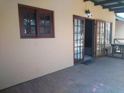 an outside view of a house with doors and a patio at 27 Pendleberry Grove, Chris Hani Drive, Bela-Bela in Bela-Bela