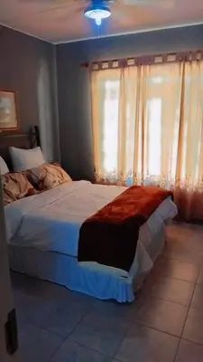 a bedroom with a bed and a window at 27 Pendleberry Grove, Chris Hani Drive, Bela-Bela in Bela-Bela