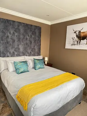 a bedroom with a large bed with two pillows at Spacious stay-in 1bedroom apartment in Kempton Park